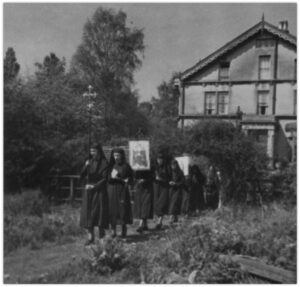 Figure 3: Members of the Confraternity of the Kingdom of Christ in procession, New Barnet, c. early 1940s (Abbey Museum).